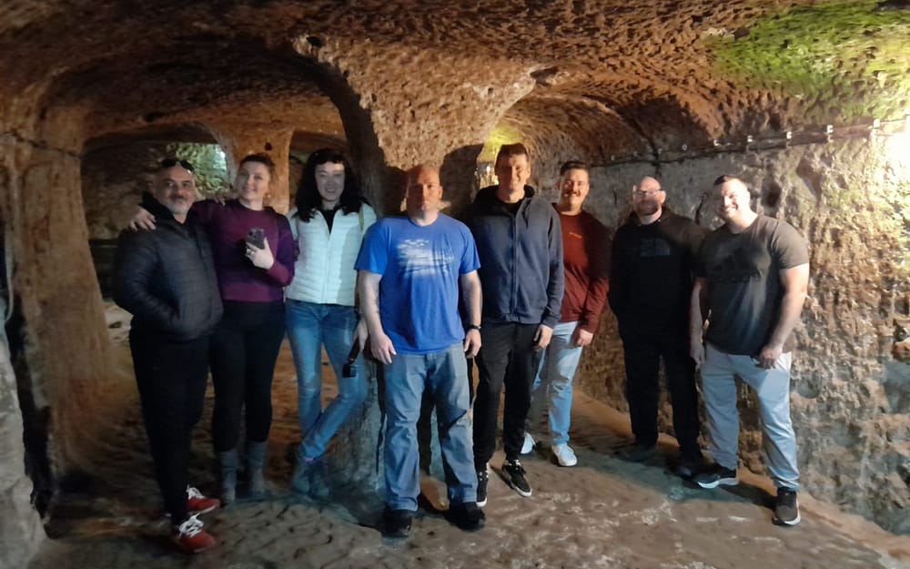 Visitors standing inside a rock-cut underground passage