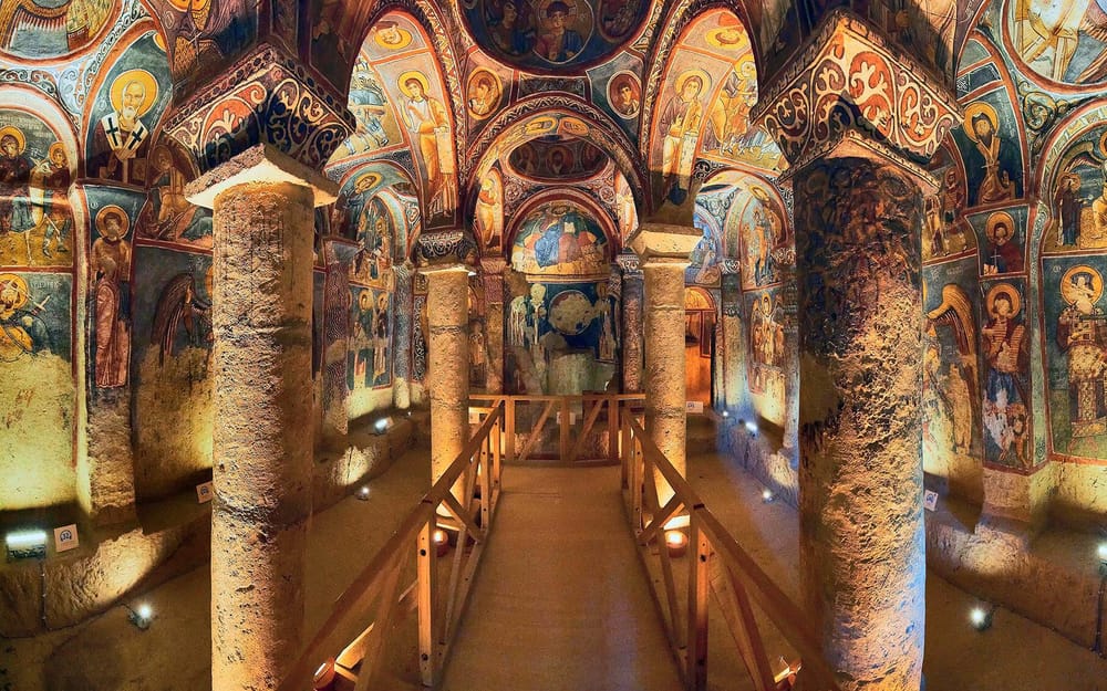 Painted arches and frescoes inside a Cappadocia cave church