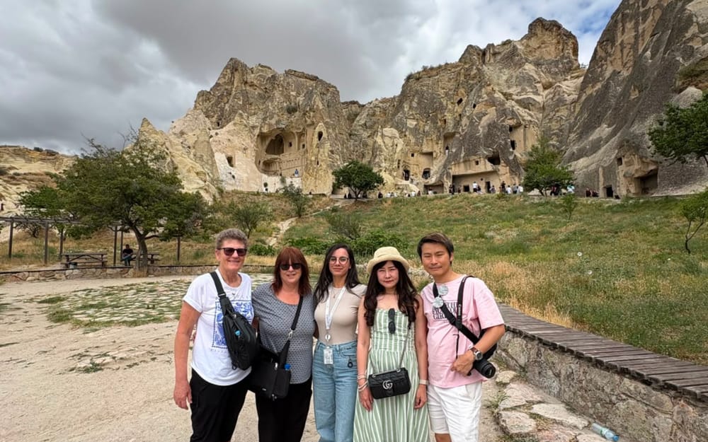 Visitors exploring a valley surrounded by Cappadocia’s rock formations