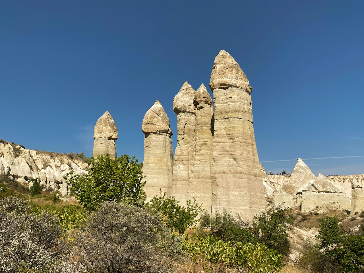 Tall fairy chimneys in Love Valley beneath a clear blue sky