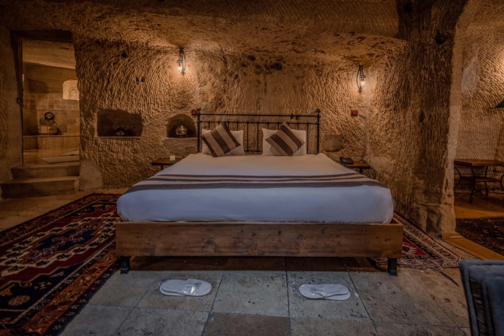 A stone-walled cave bedroom at Aydinli Cave Hotel