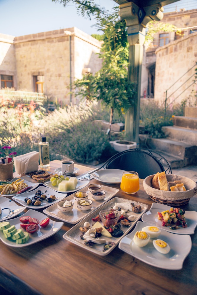 Turkish breakfast served on Aza Cave Hotel’s garden terrace